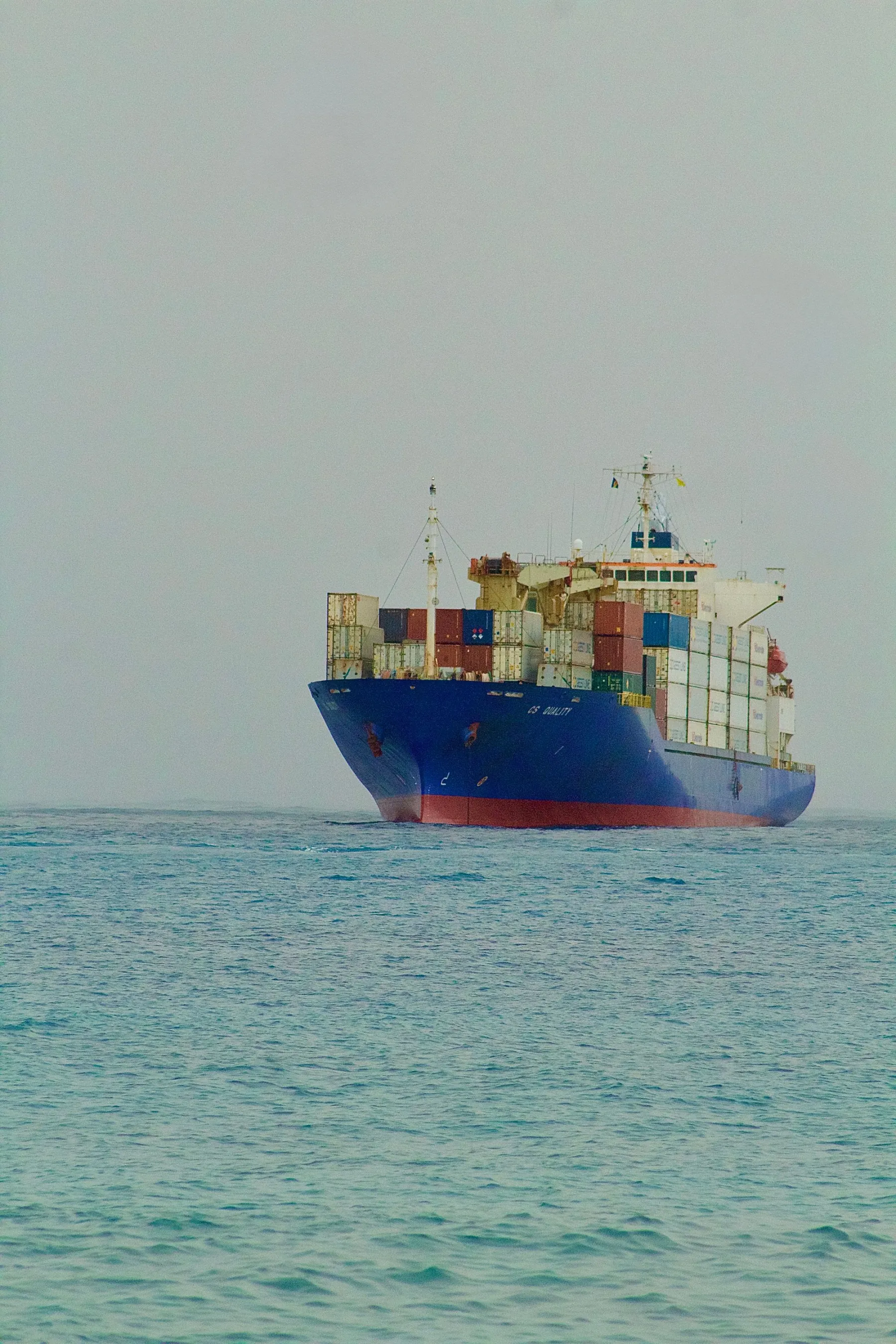 A laden container vessel bow-on under way — the per-vessel hull Polaris forecasts to the berth.